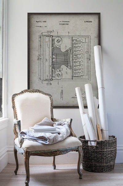 Thomson typewriter patent poster print art in room with white walls with vintage furniture and vintage decor.