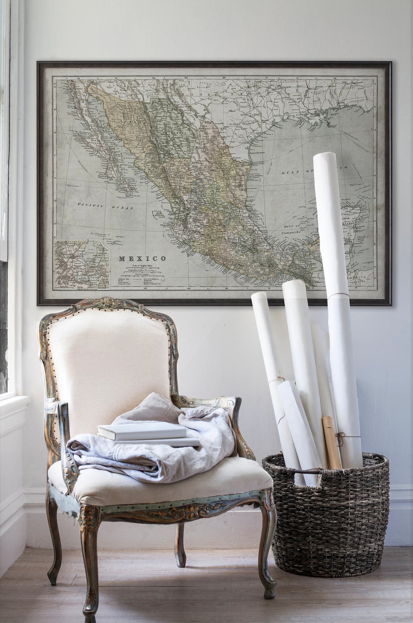 Vintage historic map of Mexico in room with white walls with vintage furniture and vintage decor.