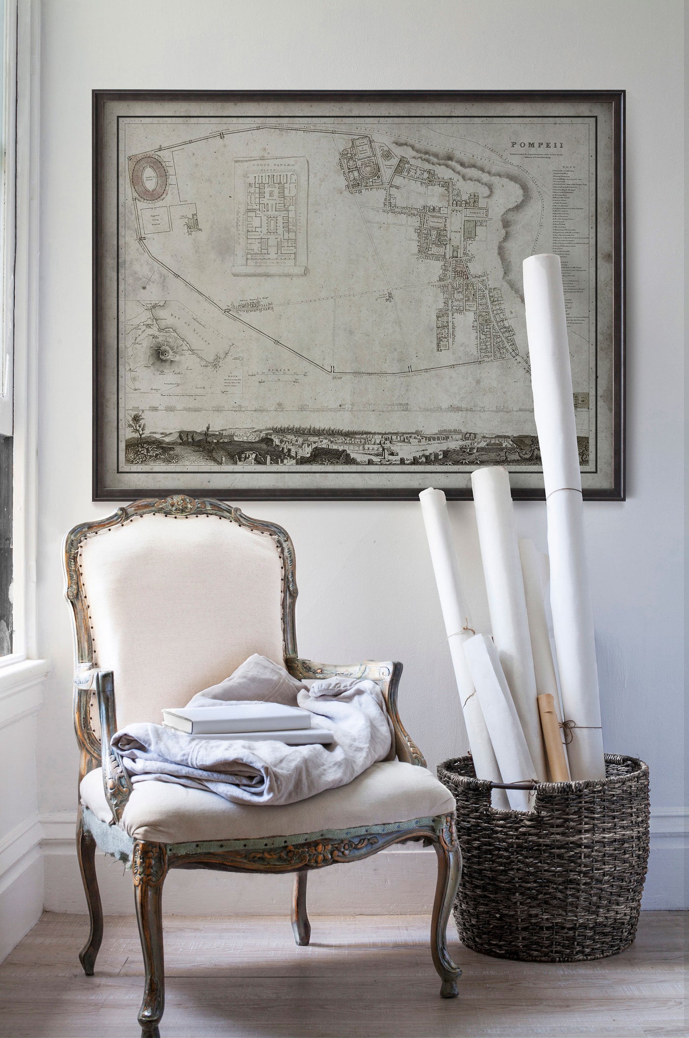 Vintage historic map of Pompeii in room with white walls with vintage furniture and vintage decor.